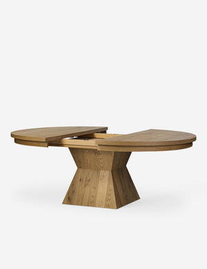 Hermoza sculptural round pedestal extendable dining table with center leaf removed.
