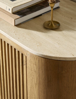 Close up of the travertine top of the Cagney sculptural vertical reeding media console.