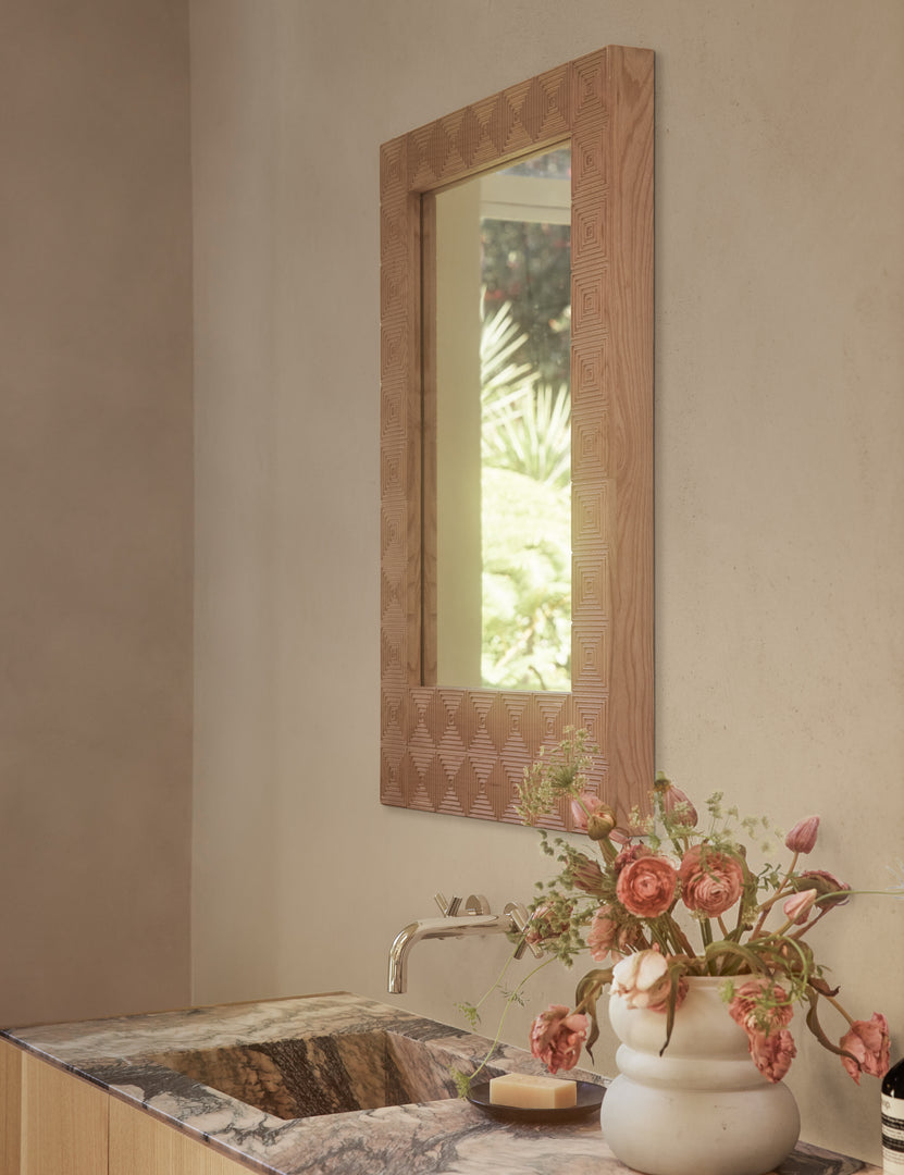 #color::natural | Chelan handcrafted carved wood frame mirror hanging above a bathroom vanity.