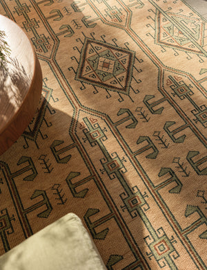 Overhead view of the Vishal geometric motif hand-knotted wool rug under a coffee table.