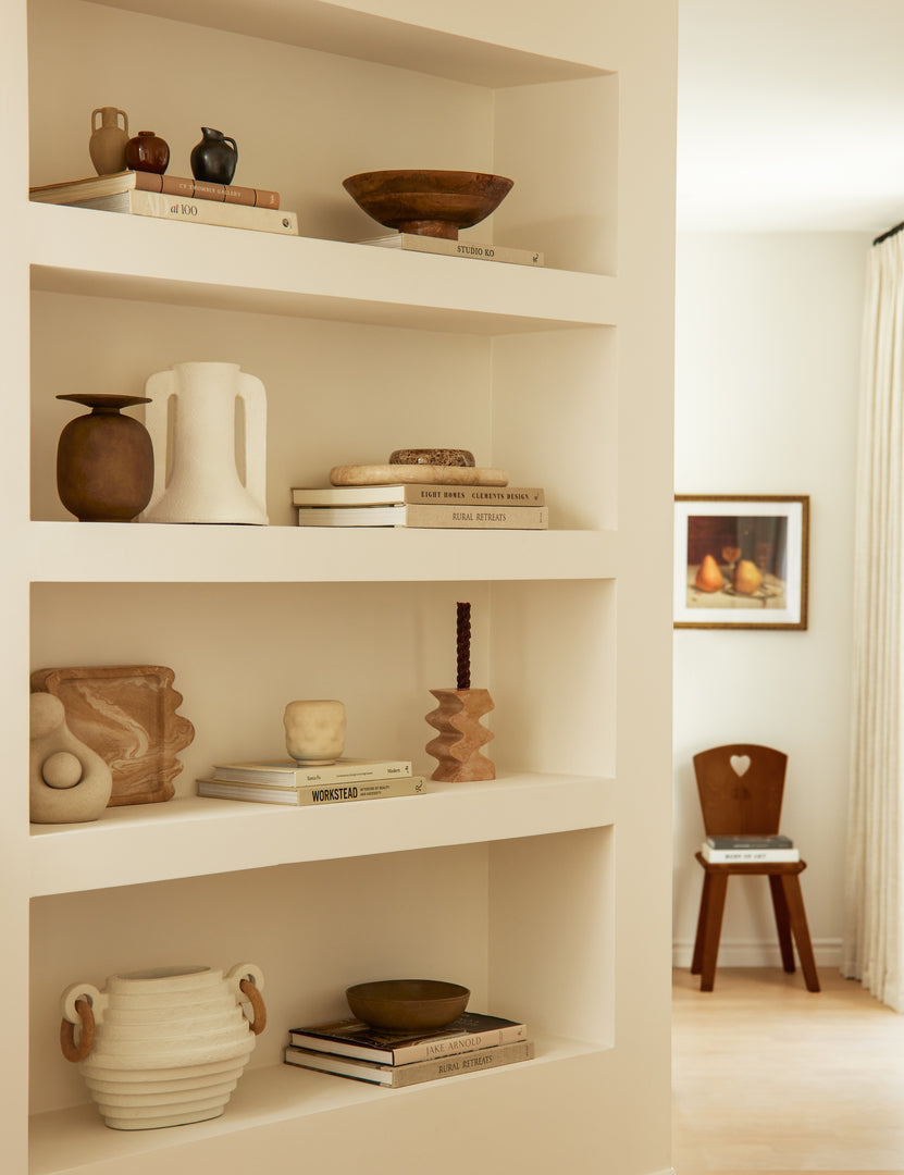 #color::travertine | Melona resin decorative tray styled on a built in bookshelf.