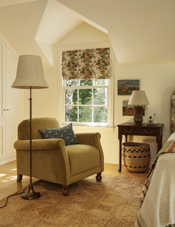 #color::aged-brass | Lily slim metal stem adjustable height floor lamp by Heidi Caillier styled next to an accent chair