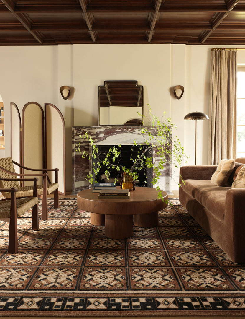 | A living room featuring the Ovidi heritage motif hand-knotted wool rug.