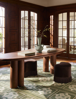 Nave modern sculptural red oak dining table by Aimee Song styled with accent stools