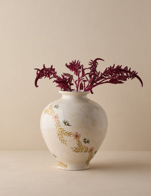 Bea floral motif ceramic vase by Heidi Caillier filled with red florals.