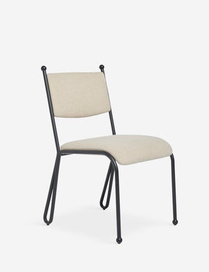 Angled view of the Fidia curved metal silhouette dining chair by Aimee Song