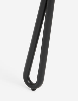 Close up of the leg of the Fidia curved metal silhouette dining chair by Aimee Song