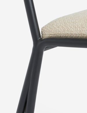 Close up of the Fidia curved metal silhouette dining chair by Aimee Song