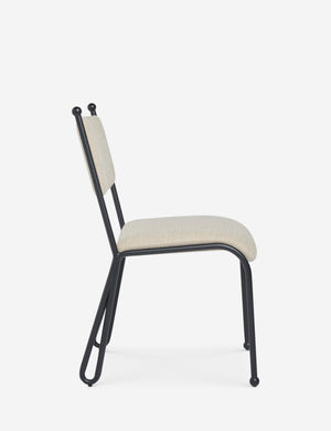Side profile view of the Fidia curved metal silhouette dining chair by Aimee Song