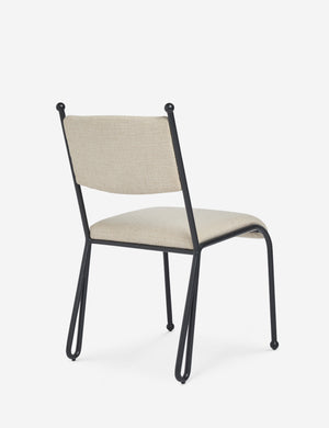 Angled back view of the Fidia curved metal silhouette dining chair by Aimee Song