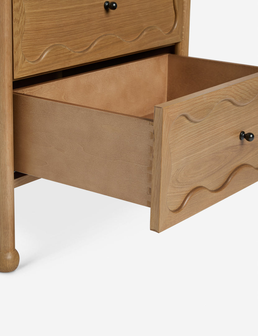 #color::natural | Close up view of the open bottom drawer of the Fontaine wavy detailing solid oak 2-drawer nightstand by Aimee Song