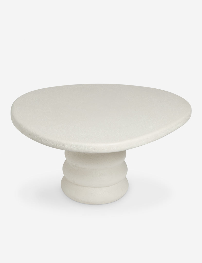 #color::ivory | Angled overhead view of the Hannu modern round fibercement dining table by Aimee Song