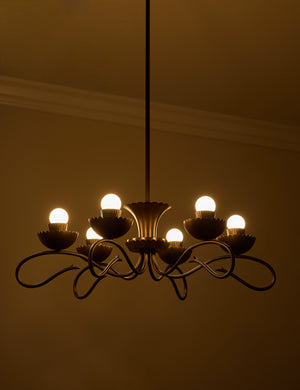 Houghton six arm iron chandelier by Heidi Caillier with the lights turned on