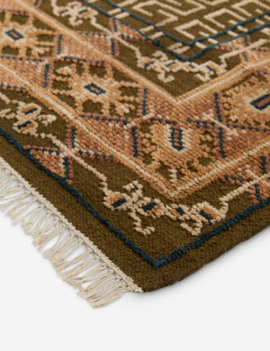 Close up of the corner of the Manca traditional geometric motif hand-knotted wool rug.