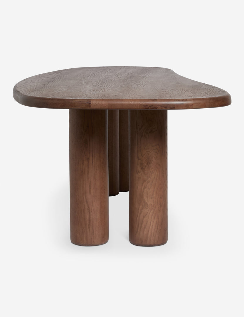 #color::cool-brown | Side profile view of the Nave modern sculptural red oak dining table by Aimee Song