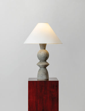 Bulsara geometric, stone-finish ceramic table lamp with the light on