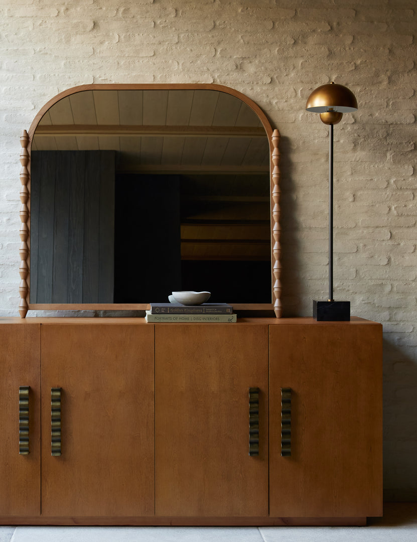 #color::natural | Topia arched carved wood mantel mirror by Ginny Macdonald in natural styled on top of a console table.