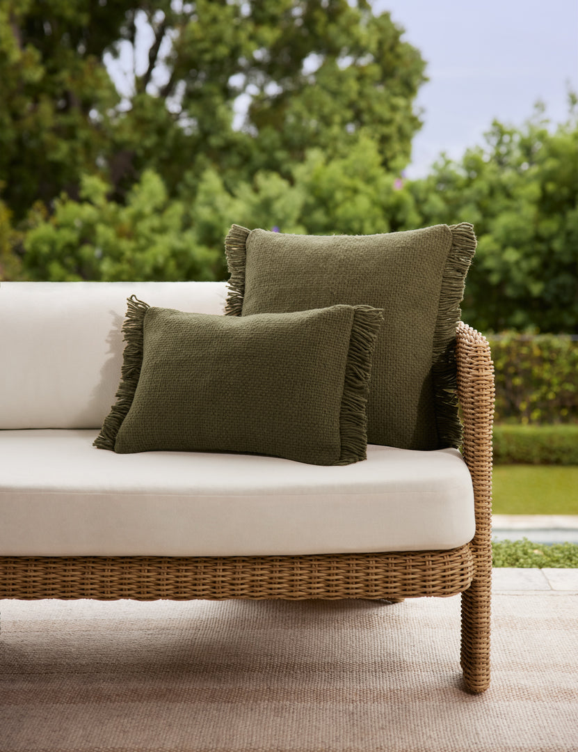 #color::moss #style::square #style::lumbar | The lumbar and square sizes of the Thorpe outdoor pillow in moss styled on an outdoor sofa.