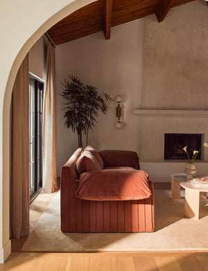 Side profile of the Yucca relaxed profile wide arm sofa by Carly Cushnie in a living room.