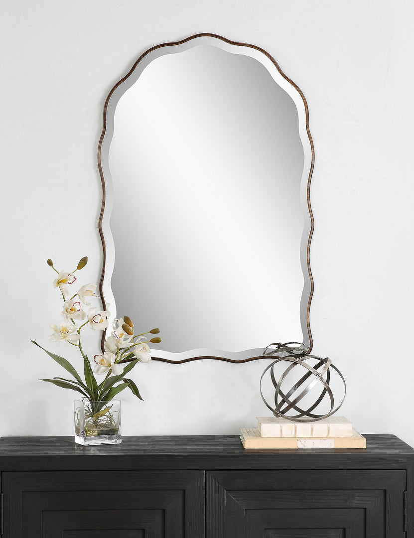 #color::brass | Gannet scalloped frame wall mirror hanging above a console table