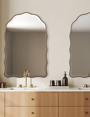 Two Gannet scalloped frame wall mirror hanging above a bathroom vanity