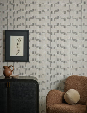 Mesa Grasscloth Wallpaper by Élan Byrd on a wall behind and accent chair and sideboard cabinet.