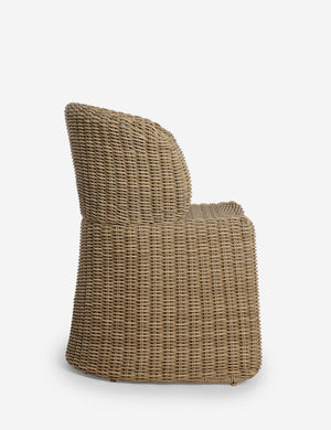 Side profile of the Mettam modern wicker outdoor dining chair.