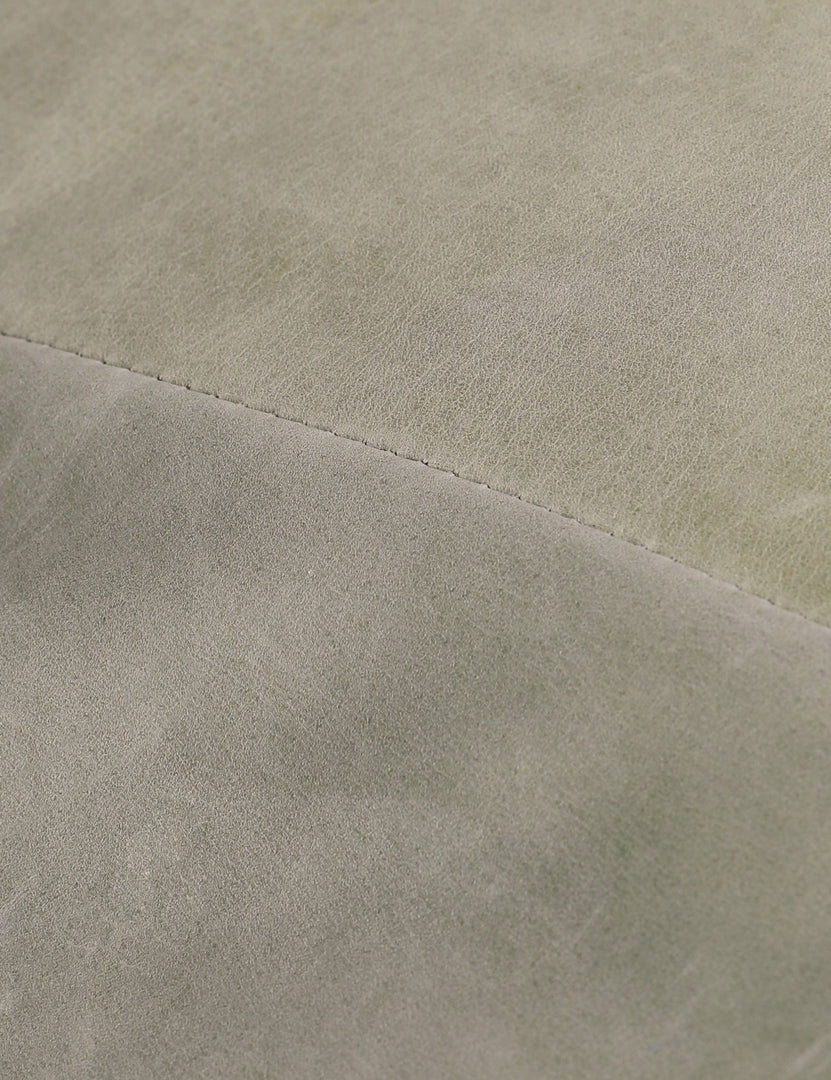 #color::sage-nubuck-leather | Close up of the leather of the Nolina relaxed open profile leather accent chair by Carly Cushnie.