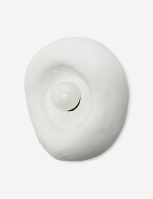 Angled view of the Odette round matte white sculptural wall sconce