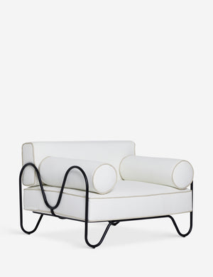 Angled view of the Peggy sculptural iron frame and white cushion outdoor accent chair.