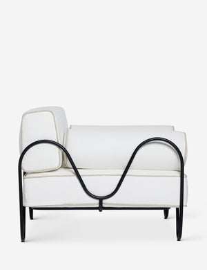 Side profile of the Peggy sculptural iron frame and white cushion outdoor accent chair.