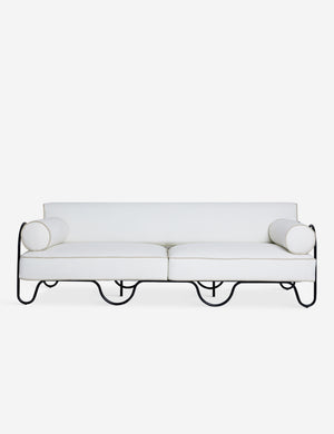 Peggy sculptural iron frame and white cushion outdoor sofa.