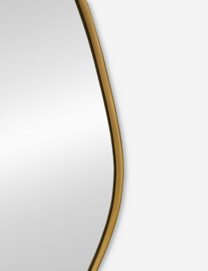 The gold curved frame on the small puddle mirror