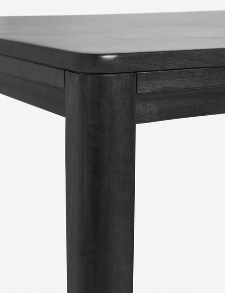 #color::black #size::82-W | Close-up of the rounded corner of the Reese black mango wood rectangular dining table.