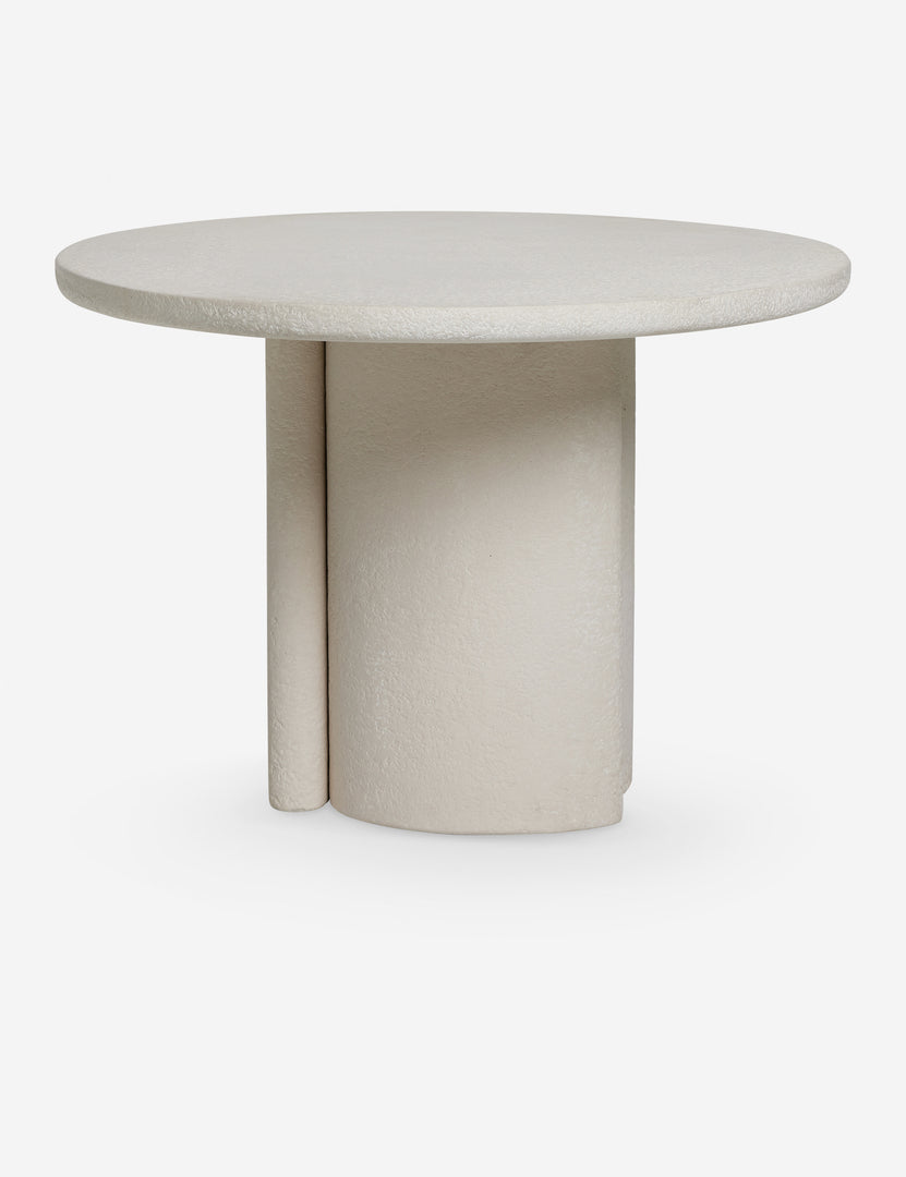 #color::natural | Side profile of the Rodrigo sculptural oval outdoor dining table.