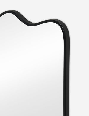 Close up view of the Rook wavy slim frame mantel mirror in charcoal