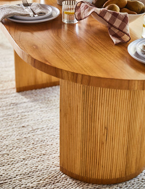 Close up of the legs of the Elvia oval rattan stacked leg dining table
