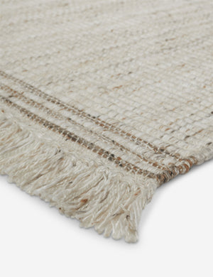 Close up of the fringe of the Sabriel handwoven large-scale striped fringed outdoor rug.