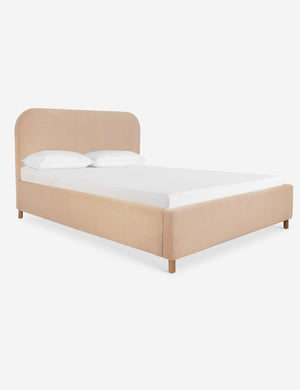 Angled view of the Solene buff pink velvet platform bed