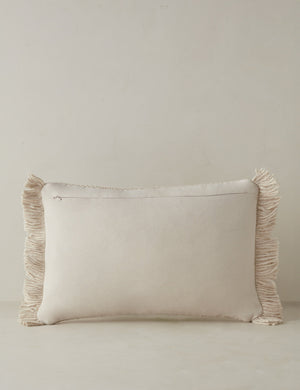 Back of the Thorpe chunky woven fringed outdoor lumbar pillow in ivory.