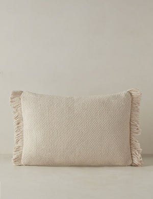 Thorpe chunky woven fringed outdoor lumbar pillow in ivory.