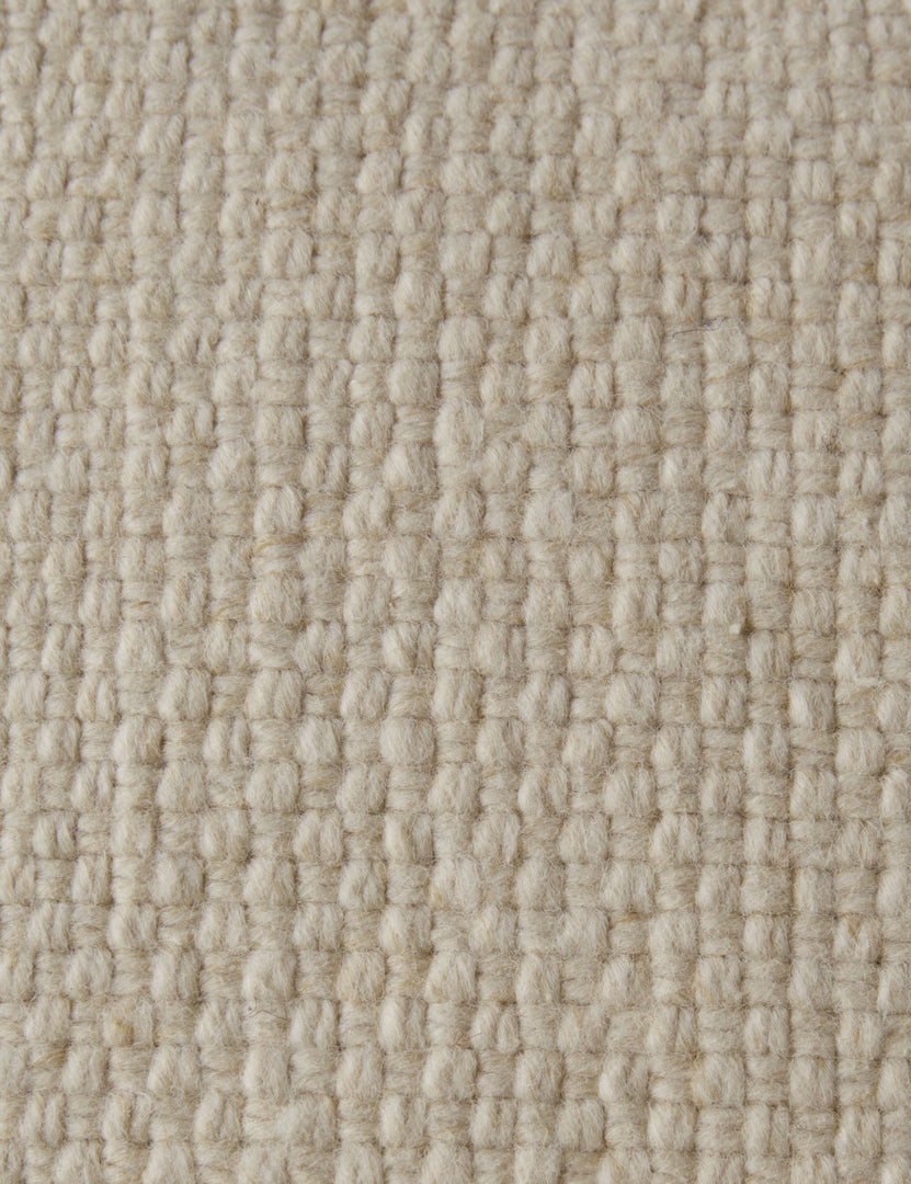 #color::ivory #style::square #style::lumbar | Close up of the Thorpe chunky woven fringed outdoor pillow in ivory.
