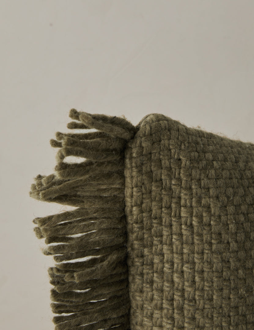 #color::moss #style::square #style::lumbar | Corner of the Thorpe chunky woven fringed outdoor pillow in moss.