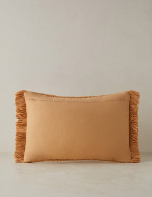 Back of the Thorpe chunky woven fringed outdoor lumbar pillow in terracotta.