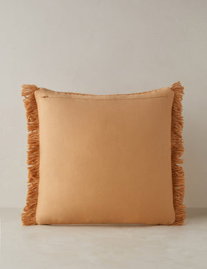 Back of the Thorpe chunky woven fringed outdoor throw pillow in terracotta.