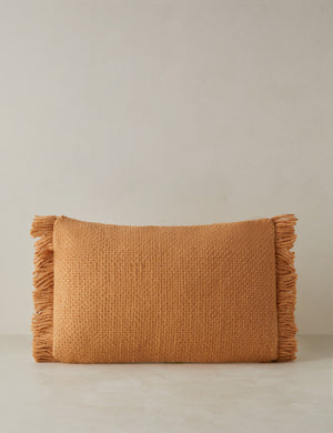 Thorpe chunky woven fringed outdoor lumbar pillow in terracotta.