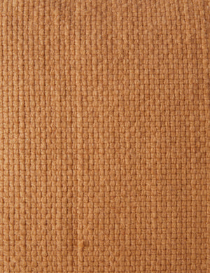 Close up of the Thorpe chunky woven fringed outdoor pillow in terracotta.