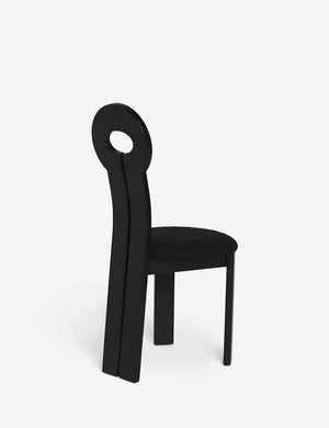 Angled rear view of the Whit black wood sculptural dining chair by sarah sherman samuel