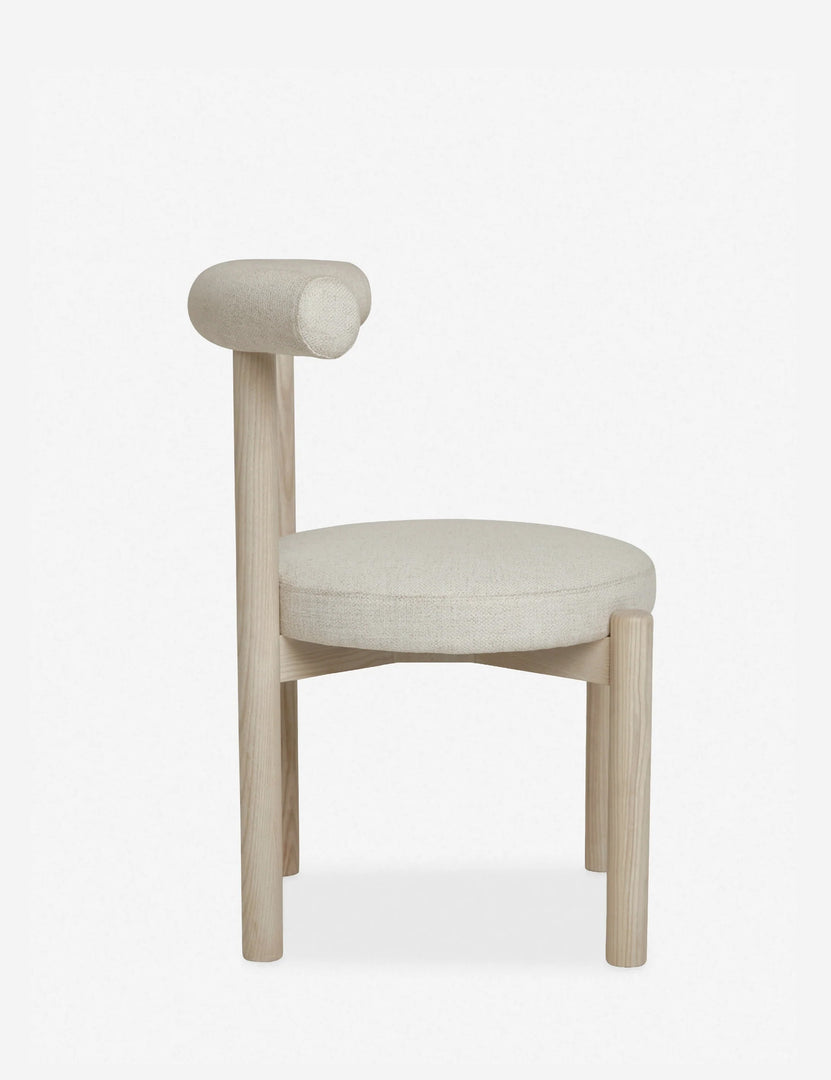 #color::whitewash | Side view of the Dame minimalist rounded open-back dining chair with ivory upholstered seat and ash wood frame 