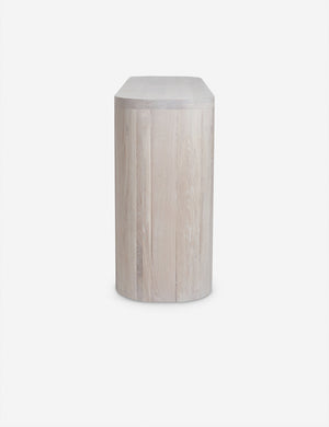 Side view of the Luna white-washed oak oval console table.